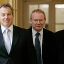 Britain's Prime Minister Tony Blair (L) walks inside 10 Downing Street with leader of Sinn Féin Gerry Adams (R) and Sinn Féin Chief Negotiator Martin McGuinness (C) before talks in London, 04 August 2005. (Photo by MIKE FINN-KELCEY/POOL/AFP via Getty Images)