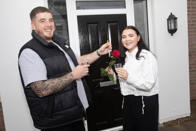 SHE SAID YES !!!! . . . .The happy couple Dylan and Chelsea pictured outside their new Braidwater Roe Wood home in Limavady on Valentine's Day after collecting their keys. (Photo: Jim McCafferty Photography)