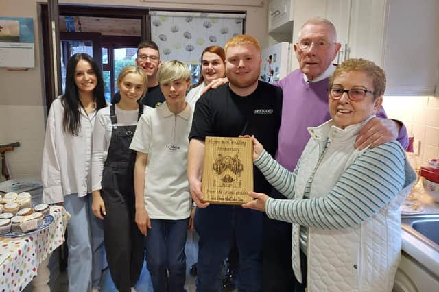 Jim and Mary Keys with their grandchildren, who presented them with a special plaque to mark their 60th wedding anniversary.