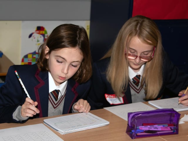Two of the Year 8 students getting their new timetables sorted at Oakgrove Integrated College on Monday. : Oakgrove Integrated College welcomes latest influx of Year 8 pupils