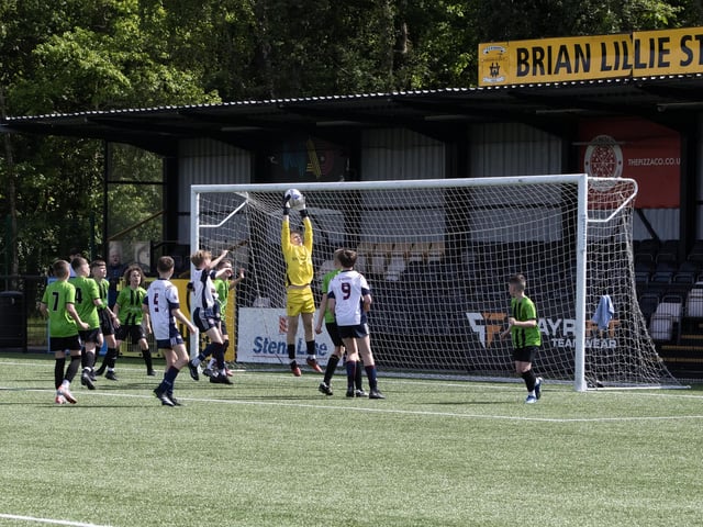SAFE PAIR OF HANDS. . . .St. Joseph's Boys Conor Clarke climbs high to collect this inswinging corner.