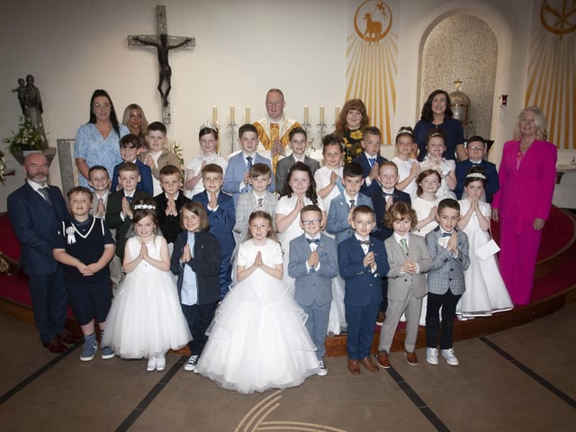 Pupils from Mrs. Aileen Mullan’s class at St. Brigid’s Primary School, Carnhill who received the Sacrament of First Holy Communion at St. Brigid’s Church on Wednesday last. At front left is Mr. Mark Doherty, and at back from left, Ms. Ashleigh McGowan, Ms. Eimear McChrystal, Fr Sean O’Donnell, Ms. Molly Meehan, Mrs. Aileen Mullan, class teacher and Ms. Mary McCallion, Principal. (Photos: Jim McCafferty Photography) 