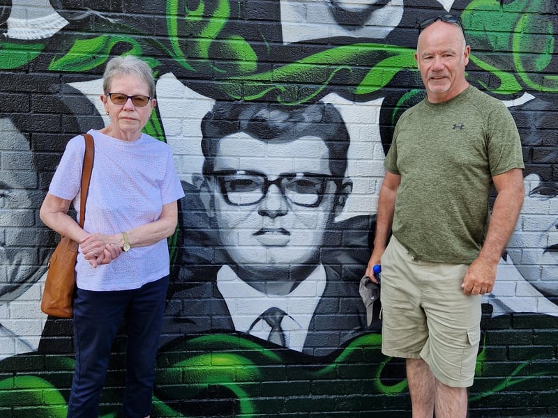 Members of William McKinney's family alongside his portrait.
