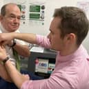 Chief Medical Officer Professor Sir Michael McBride and Mark O’Kane, pharmacist at Woodbourne Pharmacy.