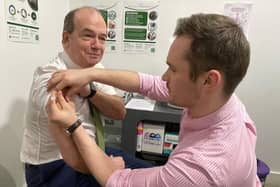 Chief Medical Officer Professor Sir Michael McBride and Mark O’Kane, pharmacist at Woodbourne Pharmacy.