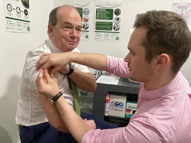 Chief Medical Officer Professor Sir Michael McBride and Mark O’Kane, pharmacist at Woodbourne Pharmacy.