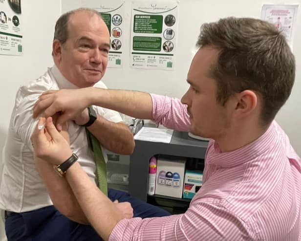 Chief Medical Officer Professor Sir Michael McBride and Mark O’Kane, pharmacist at Woodbourne Pharmacy.