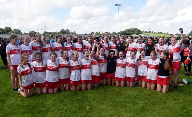 Derry players celebrate with the cup after the U16B Camogie All-Ireland Championship Final at Inniskeen Grattans, Co.  Monaghan. (INPHO/Ciaran Culligan)