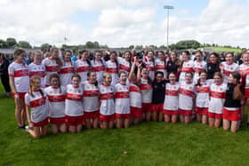 Derry players celebrate with the cup after the U16B Camogie All-Ireland Championship Final at Inniskeen Grattans, Co.  Monaghan. (INPHO/Ciaran Culligan)