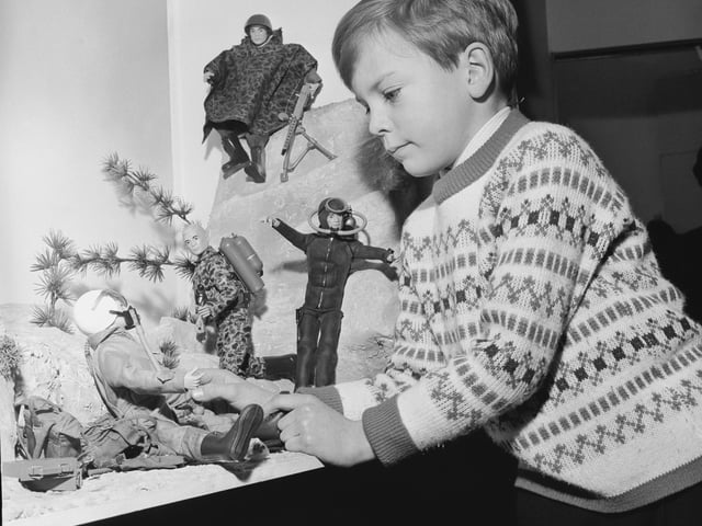 By the 80s, Action Man was already a well established toy, as shown in this picture of seven-year-old John Rider examining a display of Action Man toys made by Palitoy at the British Toy Fair in Brighton, way back in 1966. (Photo by Leonard Burt/Central Press/Hulton Archive/Getty Images)