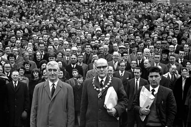 Some of the estimated 25,000 who took part in the University for Derry Campaign Motorcade from the city pose on the steps of Parliament Buildings, Stormont, Belfast, on 18th February 1965. The campaign was led by (from left) Eddie McAteer, Nationalist MP for Foyle, Albert Anderson, Mayor of Derry, and John Hume, campaign organiser.