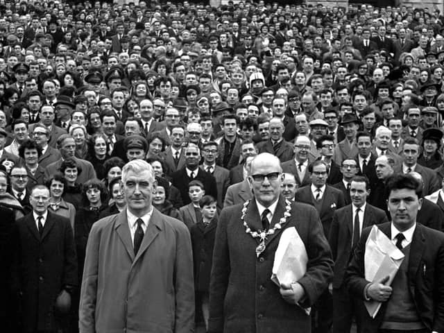 Some of the estimated 25,000 who took part in the University for Derry Campaign Motorcade from the city pose on the steps of Parliament Buildings, Stormont, Belfast, on 18th February 1965. The campaign was led by (from left) Eddie McAteer, Nationalist MP for Foyle, Albert Anderson, Mayor of Derry, and John Hume, campaign organiser.