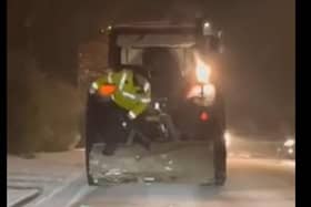 A Donegal Garda distributes road salt from the back of a tractor. An Garda Siochana Donegal Facebook