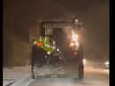 A Donegal Garda distributes road salt from the back of a tractor. An Garda Siochana Donegal Facebook