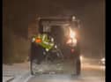 A Donegal Garda distributes road salt from the back of a tractor. An Garda Siochana Donegal Facebook