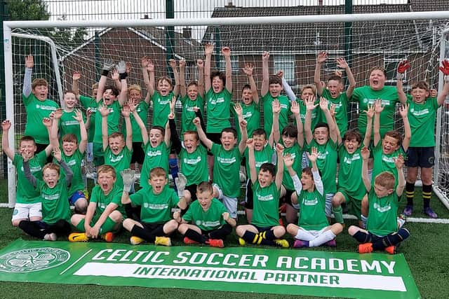 Don Bosco's players celebrate after taking part in the summer camp last year when Celtic Academy coaches arrived at Leafair pitches to take them through their training sessions.
