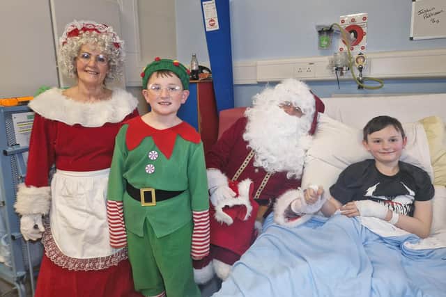 Mr and Mrs Claus with eight year old Justin Pattinson.