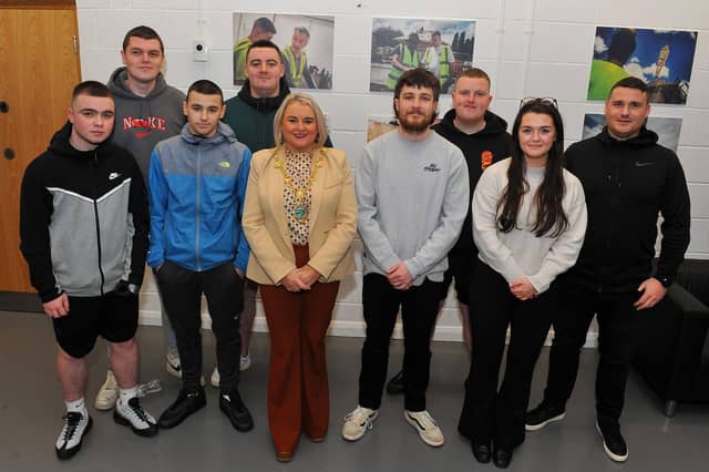 Mayor Sandra Duffy and videographer Ruairi Campbell pictured with young people who helped construct David Best’s temporary space of healing’ Sanctuary’ in Bedford, England, to commemorate those who lost their lives during the Covid – 19 pandemic. The film premiere of Ruairi’s ‘Sanctuary’ and a photographic exhibition launch took place on Wednesday evening last in St Mary’s Youth Club, Creggan. Photo: George Sweeney. DER2308GS – 11