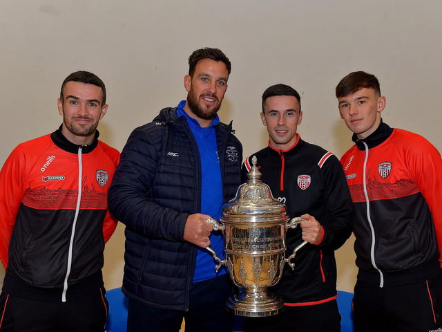 Derry City players Michael Duffy, Jordon McEneff and Liam Mullan, former pupils of St Columb's College, pictured with PE teacher Mark Scoltock during a visit to the school with the FAI Cup, on Monday. Photo: George Sweeney. DER2247GS 33