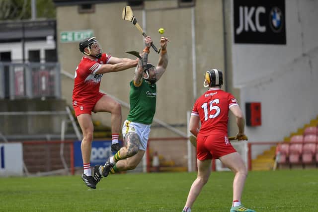 Derry’s Deaghlan Foley and Shea Cassidy contest possession with Meath’s Michael Burke.  Photo: George Sweeney