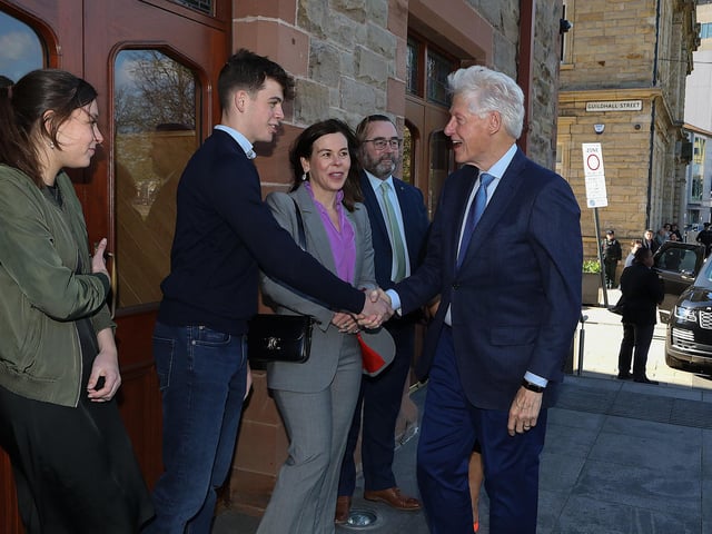 John Hume's grandson Ollie greets Bill Clinton.