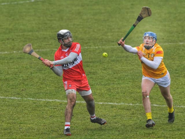 Antrim's Connor Dickson attempts to block a shot from Keelan Doherty of Derry. (Photo: George Sweeney)