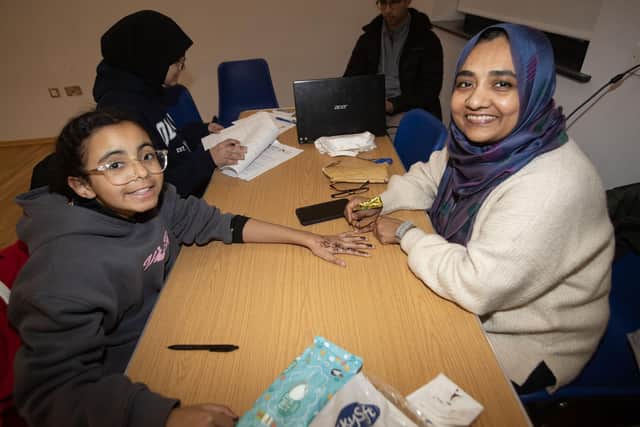 Young Nyla Obinna gets some Henna tattoos at Wednesday night's 'Out and About' event at the Waterside Shared Village. : .