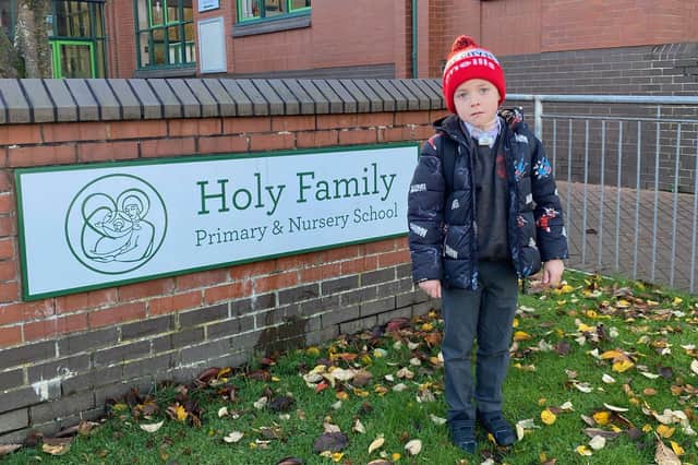 James McBride (7) outside his primary school in Derry.