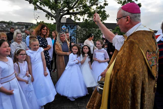 Children being blessed by The Most Reverend Dr Dónal McKeown, Bishop of Derry, during the traditional Saint Colmcille Feast Day Blessing at St Columba’s Well in the Bogside in 2022. Photograph: George Sweeney. DER2224GS – 035