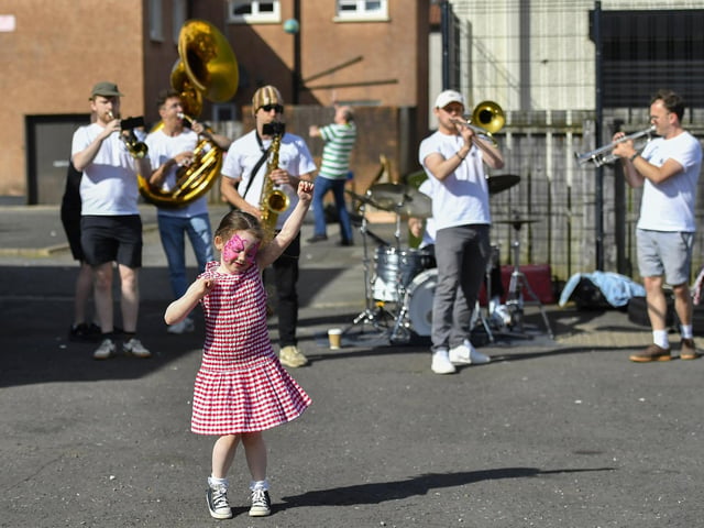A young girl dances to the sounds of the Top Tier Brass Band playing in Meenan Square . Photo: George Sweeney