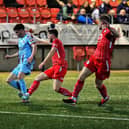 Jamie Rea and Ben Murdock of Loughgall track Institute’s Dean Brown. Photograph: George Sweeney
