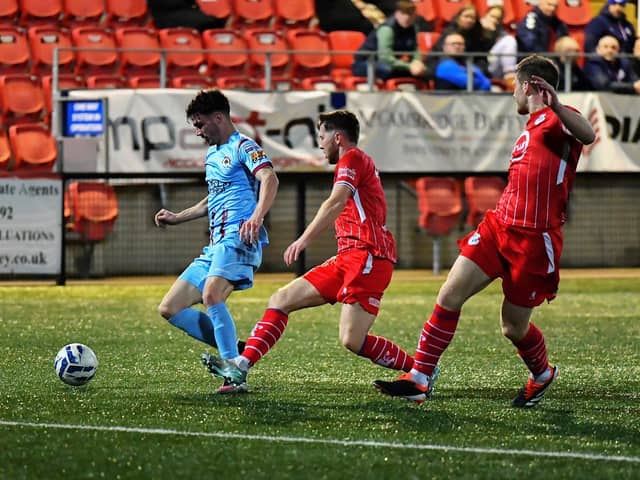 Jamie Rea and Ben Murdock of Loughgall track Institute’s Dean Brown. Photograph: George Sweeney
