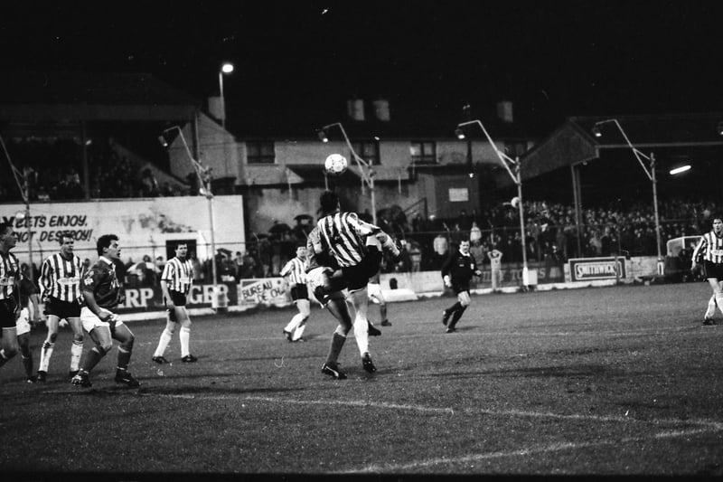 John Mannion challenges for the ball in the Derry City box.