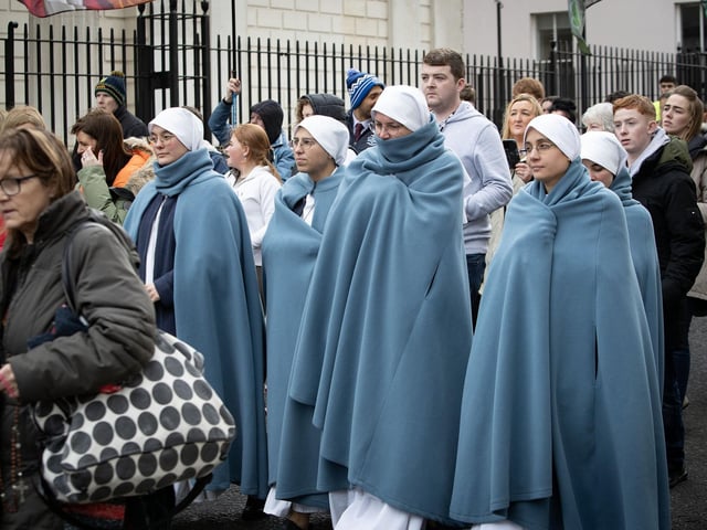 Nuns taking part in Saturday's. procession make their way down Bishop Street.