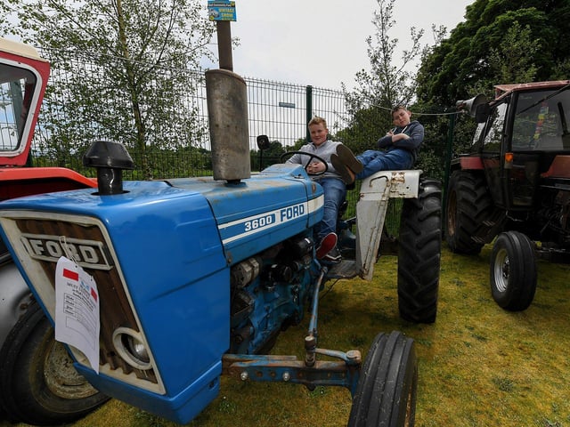 Darlagh McCarron and Daniel Lynch pictured on a Ford 360 tractor at the Muff Vintage Show, held in the Community Park on Sunday. Photo: George Sweeney.