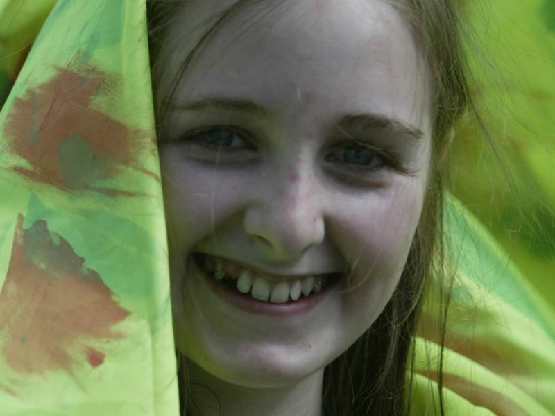 Peekaboo....  This young lady sneaks a peek out of her float at the Hiring Fair festival. (0107JB66)