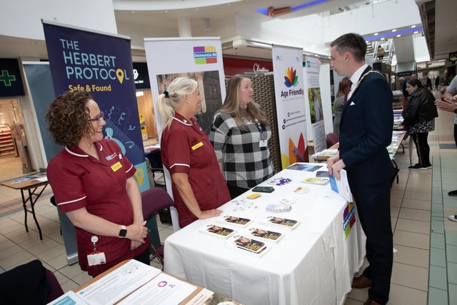 The Deputy Mayor in converstion with some of the professional staff at the 'One Stop Shop' for information on dementia at Foyleside on Thursday morning.