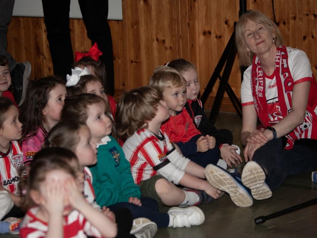 Mrs Grace pictured with some of her Nursery class listening to Mark's address on Tuesday.