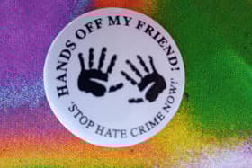A badge from a previous anti-racism campaign in Derry - Hands Off My Friend.