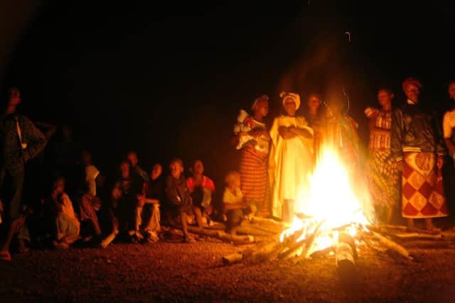 People gathered at a bonfire in Sierra Leone. Photo by Sara Terry for Catalyst for Peace.