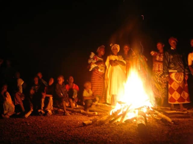 People gathered at a bonfire in Sierra Leone. Photo by Sara Terry for Catalyst for Peace.