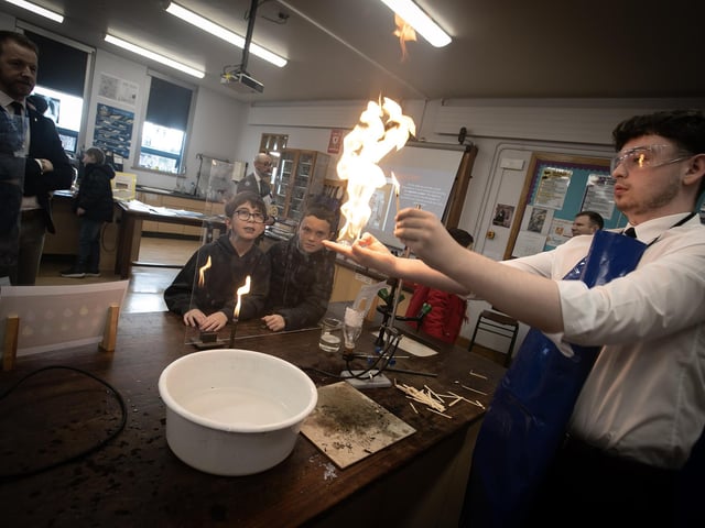 Two young pupils enjoy this 'fire experiment' during a visit to the Science Department on Saturday.