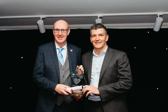 Mark Gillespie accepts award on behalf of Dr Pat Podmore, winner in the Frontline Champion of the Year Award category.