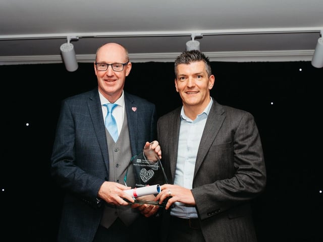 Mark Gillespie accepts award on behalf of Dr Pat Podmore, winner in the Frontline Champion of the Year Award category.