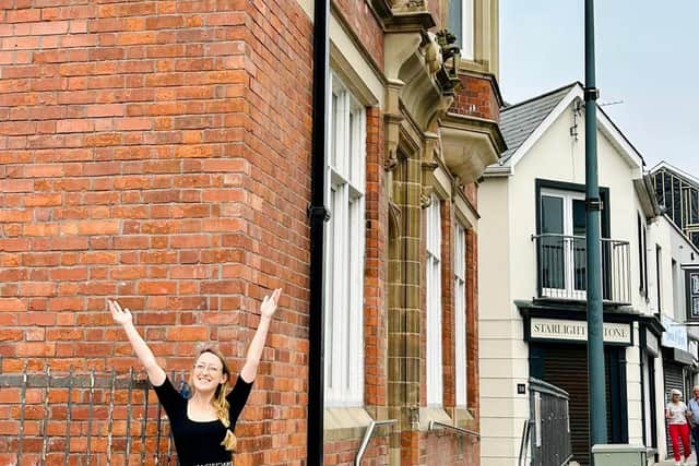 Natasha Kirke General Manager outside the SafeHouse Cafe Bar and Bank Apartments