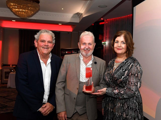 Business Person of the Year Award winner Seamus Nealis receives his award from Calor Regional Sales Manager for NI Mary McGee and compere Adrian Logan. Photo: George Sweeney