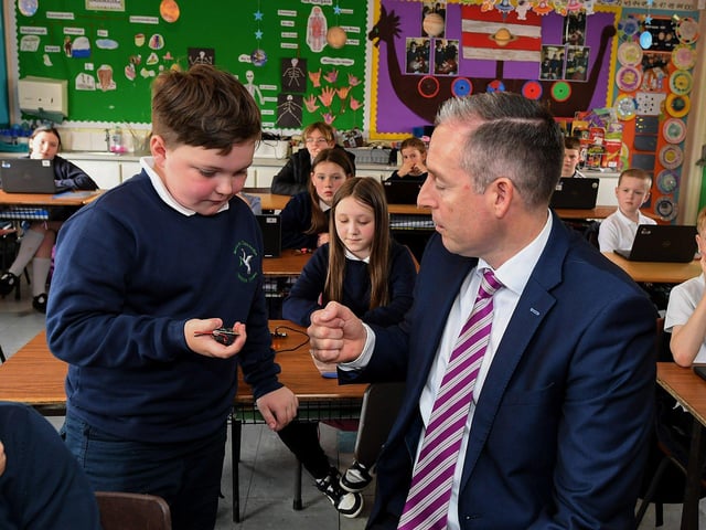 Oisin explains Coding using Microbits to Education Minister Paul Givan during his visit to the Naíscoil Dhoire and Bunscoil Cholmcille, Steelstown, on Wednesday morning. Photo: George Sweeney