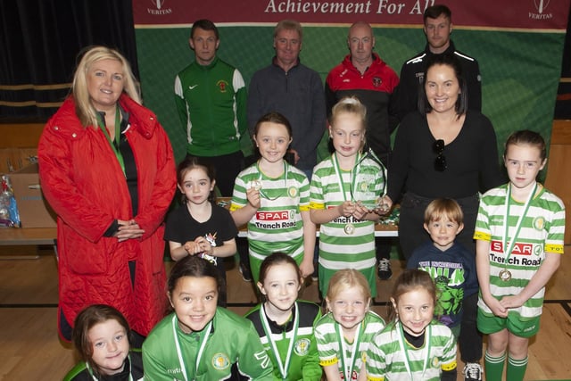 WELL DONE GIRLS. . . . .The Top of the Hill Celtic Girls 2014 team receiving their medals from Ciara McGlynn, (Sean’s sister) on Sunday. Included are Mrs. Ciara Deane, Principal, St. Joseph’s, Emmet McGinty, teacher/organiser, Paul Kealey, Vice Principal, Christy McGeehan, organiser and Cameron McJanett, Derry City FC.
