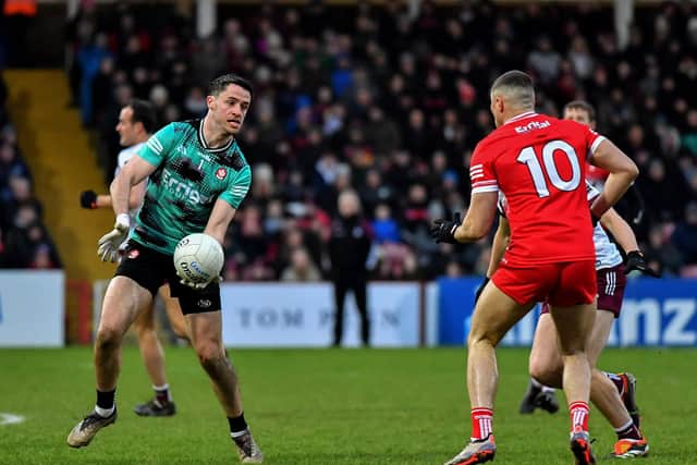 Derry goalkeeper Neil McNicholl off loads the ball to Ciaran McFaul during the game against Galway. Photo: George Sweeney