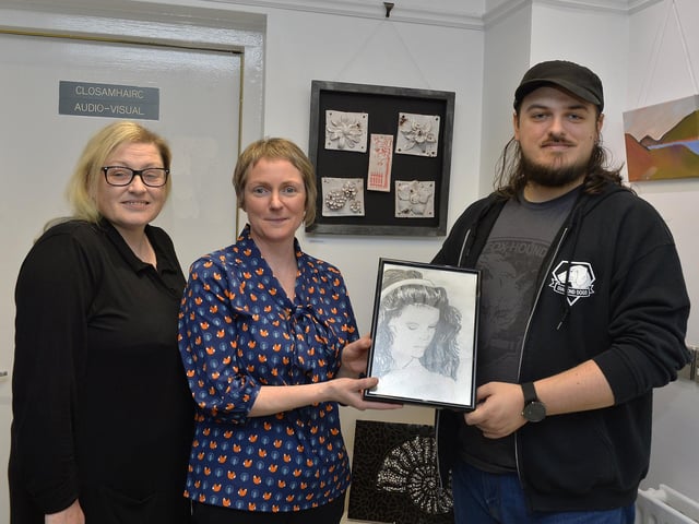 Tutor Judi Logue, centre, pictured with art students Eileen Garnon and her son Martin with their exhibits at the recent Eden Place Arts Centre Student Christmas Exhibition.  DER4718GS020